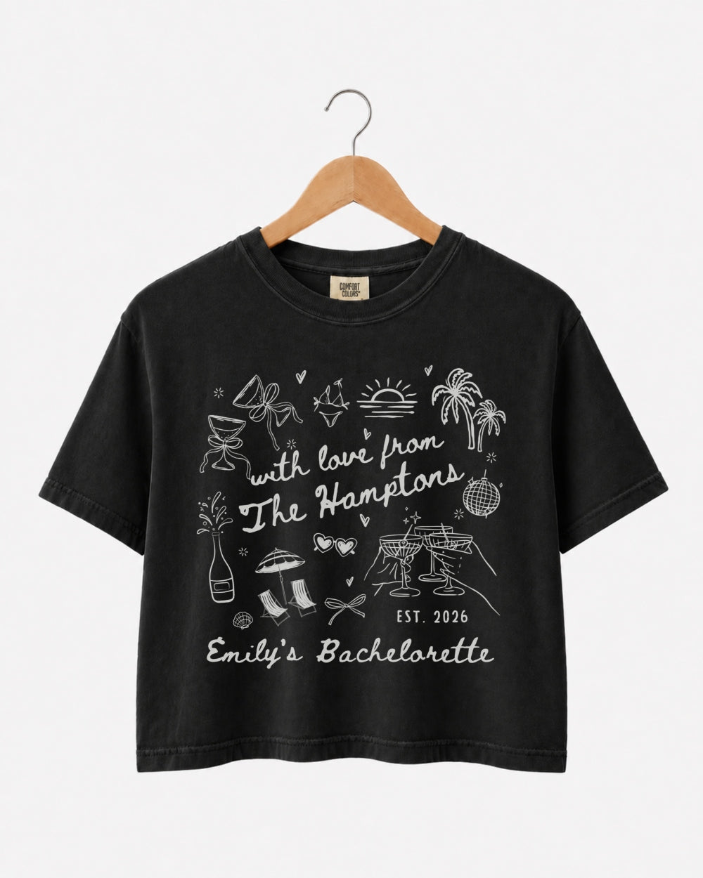 Matching crop tops for the bachelorette crew with a Hamptons weekend theme and playful doodle art. Personalized with bride name, year, and destination for the whole party.
