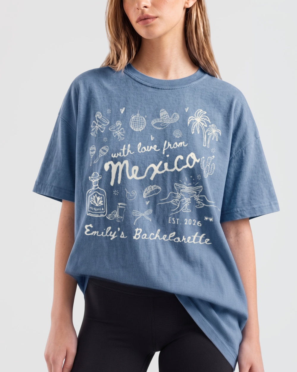 Relaxed-fit bachelorette t-shirt with vintage botanical line-art and script lettering, Mexico destination weekend theme. Personalized with bride name, year, and destination for the whole crew.
