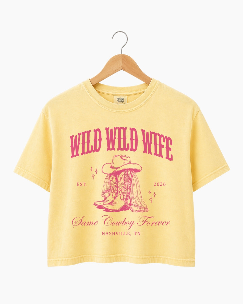 Maid-of-honor gift idea: Wild Wild Wife cowgirl bachelorette crop top with vintage western script. Personalized with bride name, year, and destination city for the full Nashville crew.