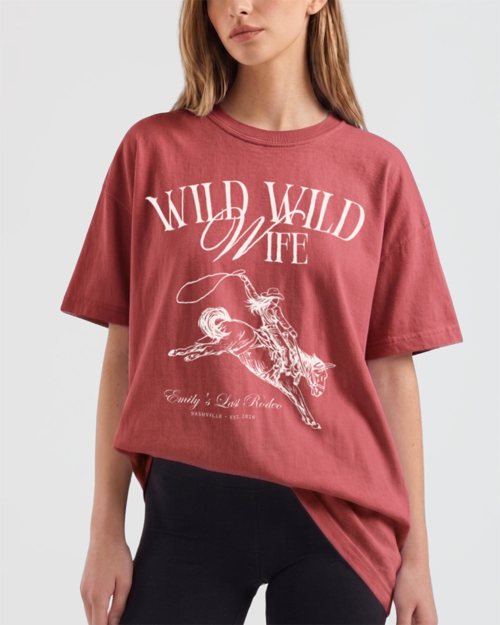 Personalized Wild Wild Wife bachelorette tee with vintage western rodeo illustration and script lettering. Customize with the bride's name, date, and destination city for the full cowgirl crew.