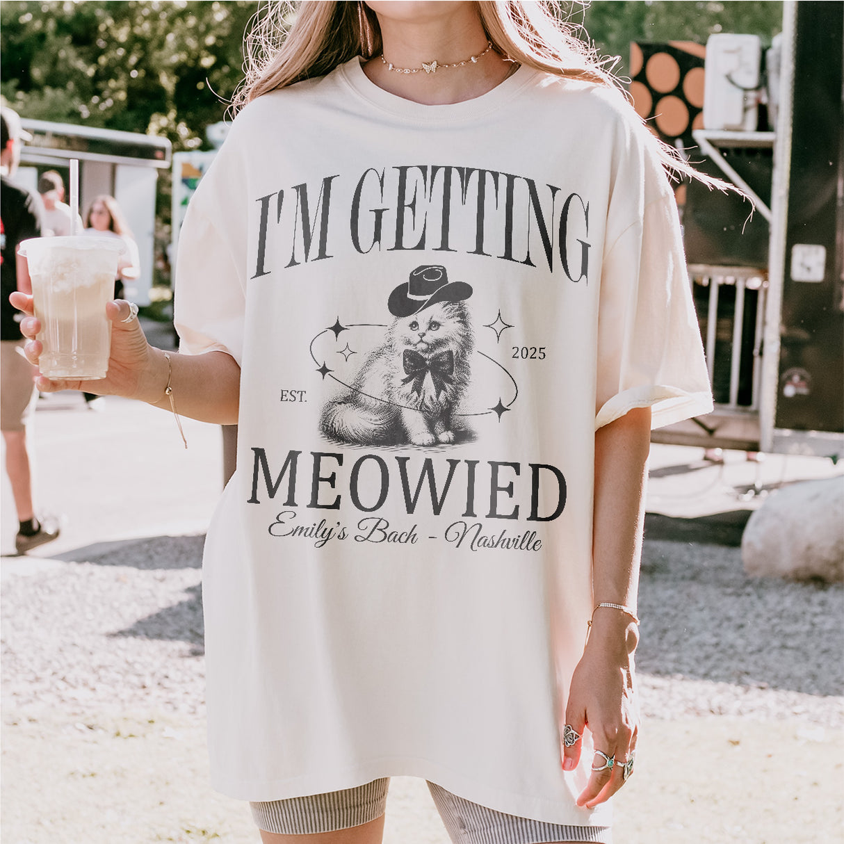Woman wearing cute cat-themed bachelorette party shirts for the bride-to-be's getting meowied celebration