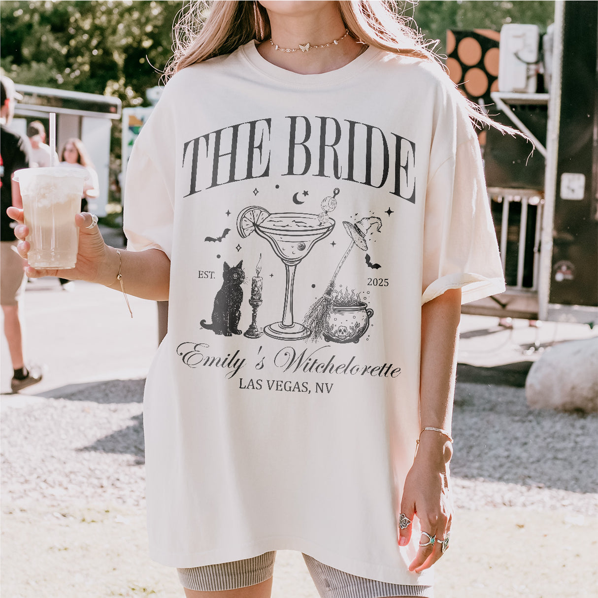 Witchy bachelorette bride and bridesmaids wearing spooky gothic coven shirts at a Halloween or gothic-themed bridal party celebration