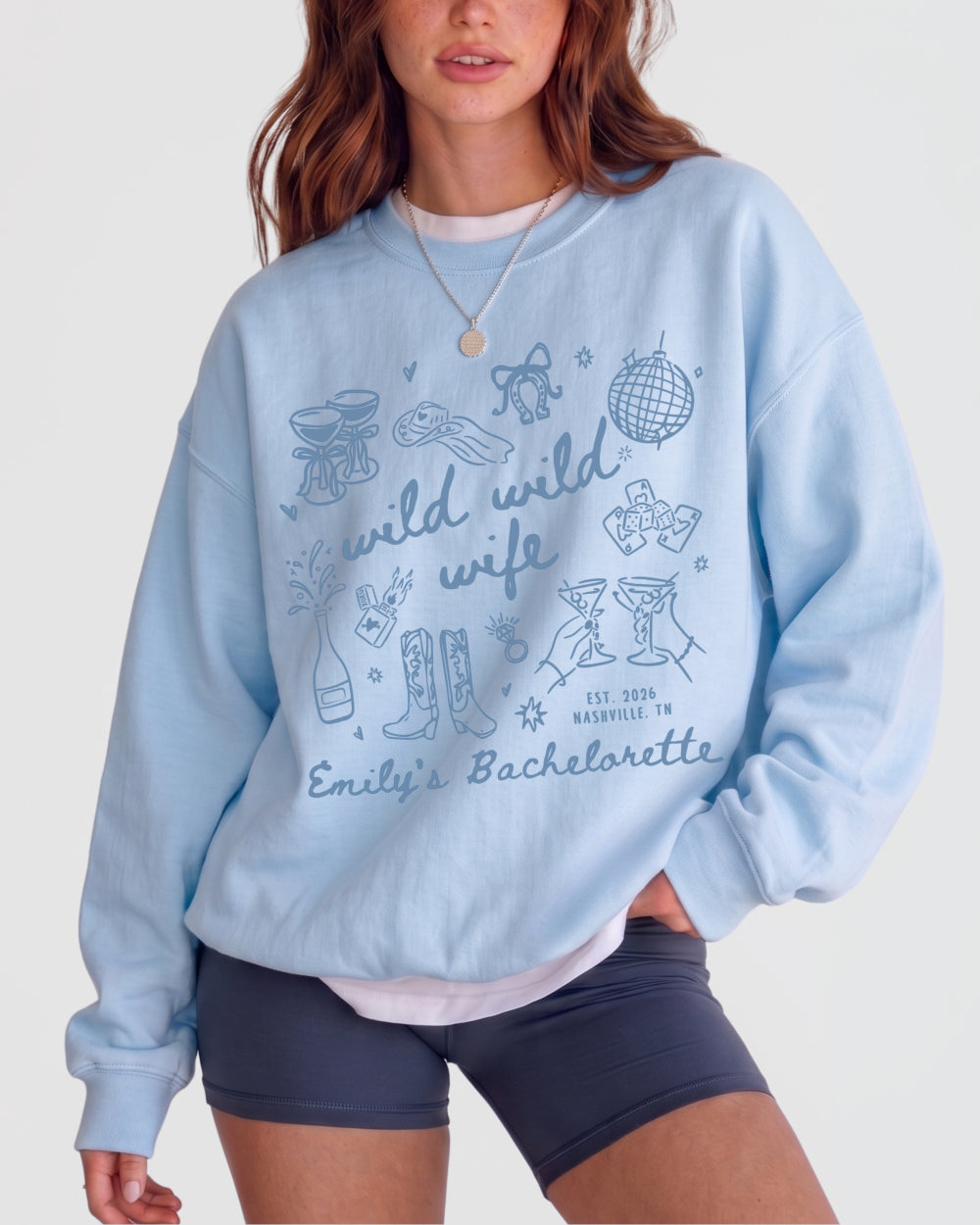 Crewneck bachelorette sweatshirt with Wild Wild Wife doodle art for the bride and her crew. Personalized with bride name, weekend date, and destination city for the full matching set.