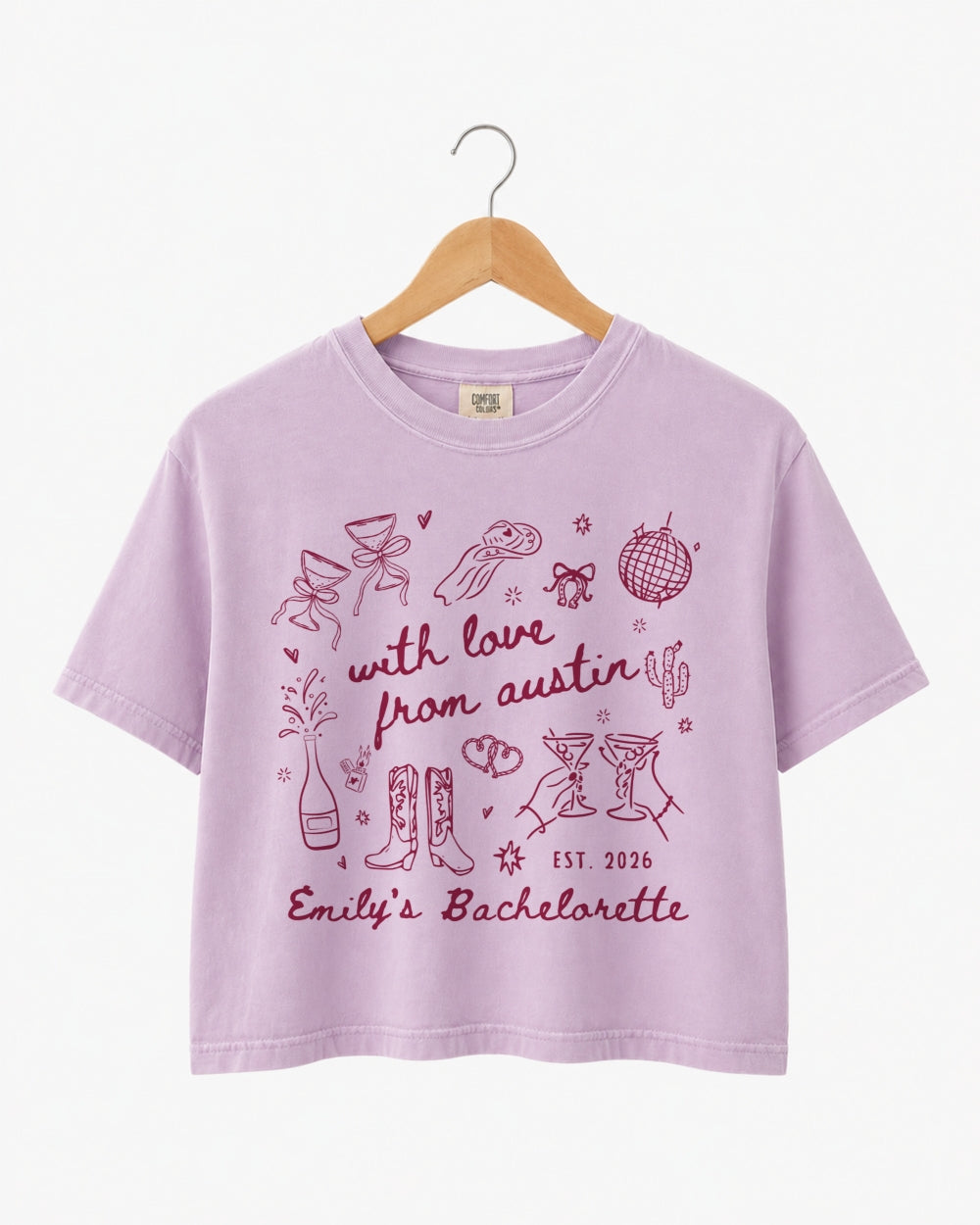 Bride and bridesmaids in matching bachelorette crop tops with minimalist doodle script art. Personalized with the bride's name, year, and city for the full Austin-inspired crew.