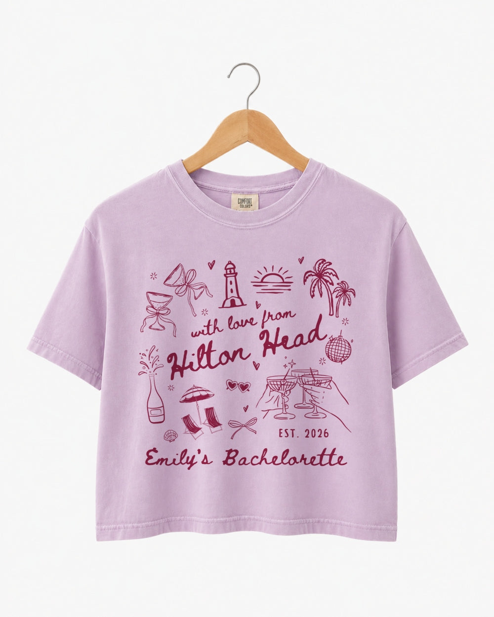 Bride and bridesmaids matching crop tops for a Hilton Head bachelorette weekend. Playful doodle art with hand-drawn script, personalized with bride name, destination, and date for the whole crew.
