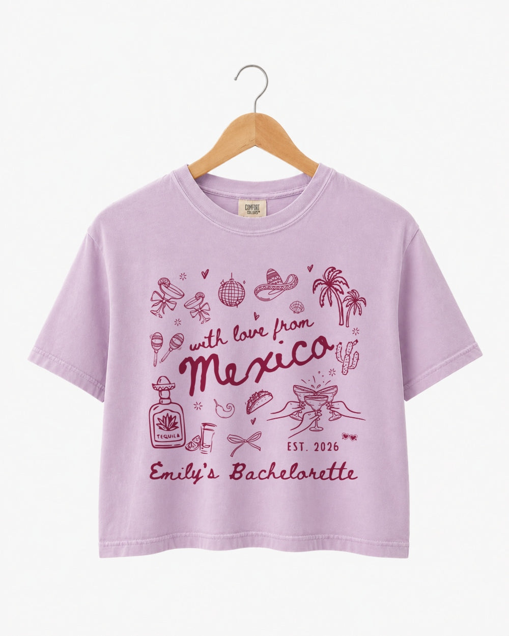 Bride and bridesmaids in matching Mexico bachelorette crop tops with playful hand-drawn script art. Personalized with bride name, destination, and year for the full crew.