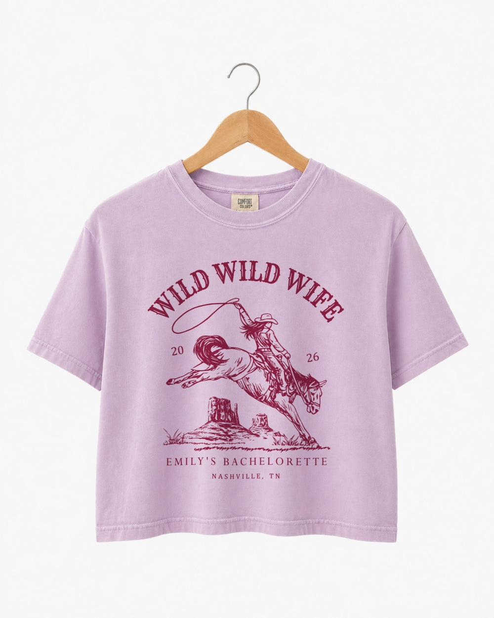 Bride and bridesmaid crop tops for a Wild Wild Wife bachelorette weekend with vintage western rodeo art. Personalize with bride name, year, and destination city for the full crew.