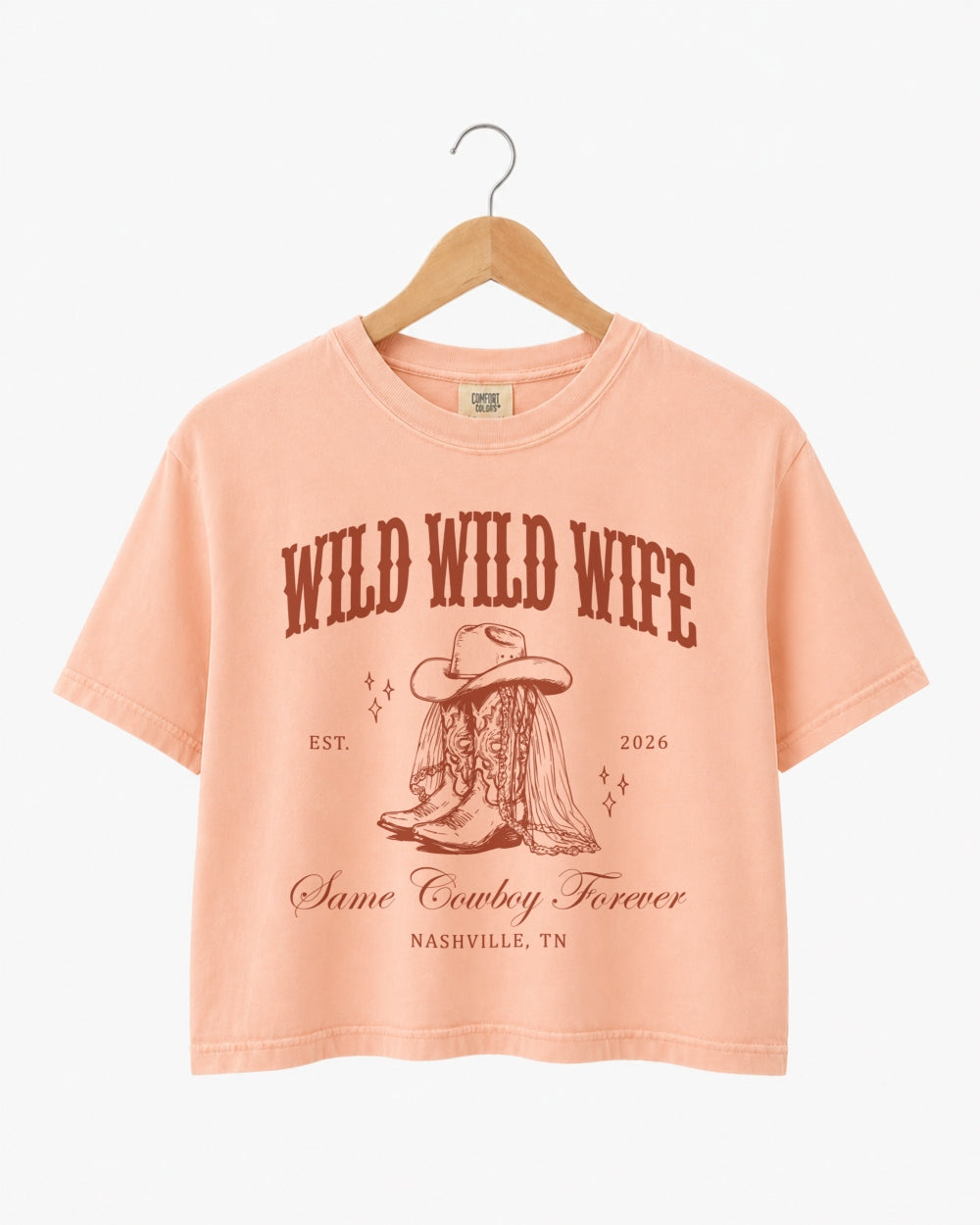 Cropped bachelorette top with vintage western illustration and script typography for a cowgirl bride bachelorette. Personalized with bride name, year, and destination city for the full Nashville crew.
