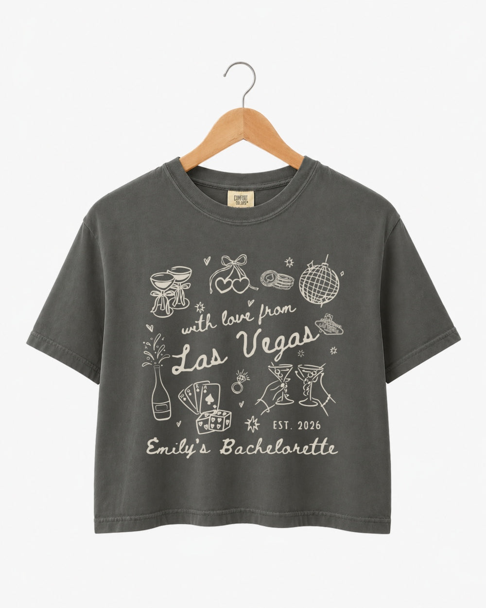 Cropped bachelorette top with vintage line-art illustration and script lettering for a Las Vegas girls weekend. Personalized with bride name, year, and destination city for the whole crew.
