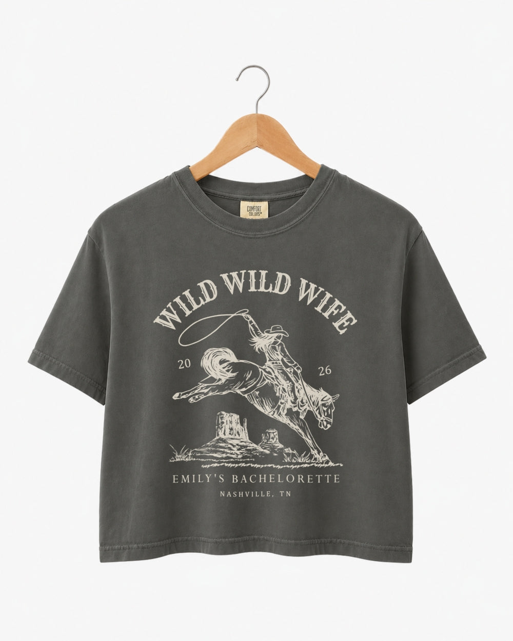 Cropped bachelorette tee with vintage western rodeo art for the Wild Wild Wife crew. Personalize with bride name, date, and destination city for every member of the bridal party.