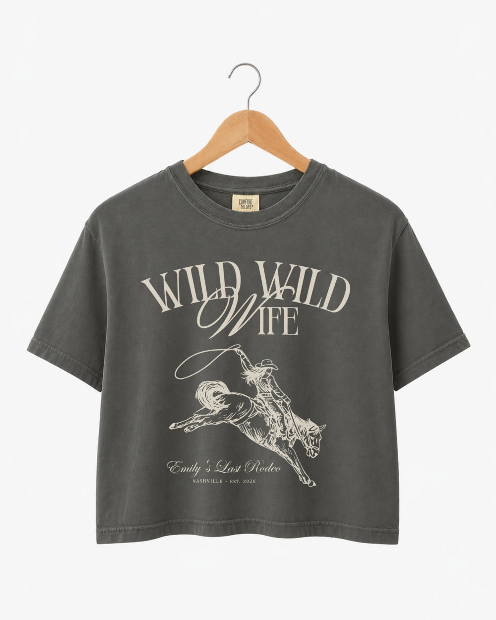 Cropped bachelorette tee with vintage western illustration for the Wild Wild Wife crew. Personalized with bride name, destination city, and year for the whole rodeo party.