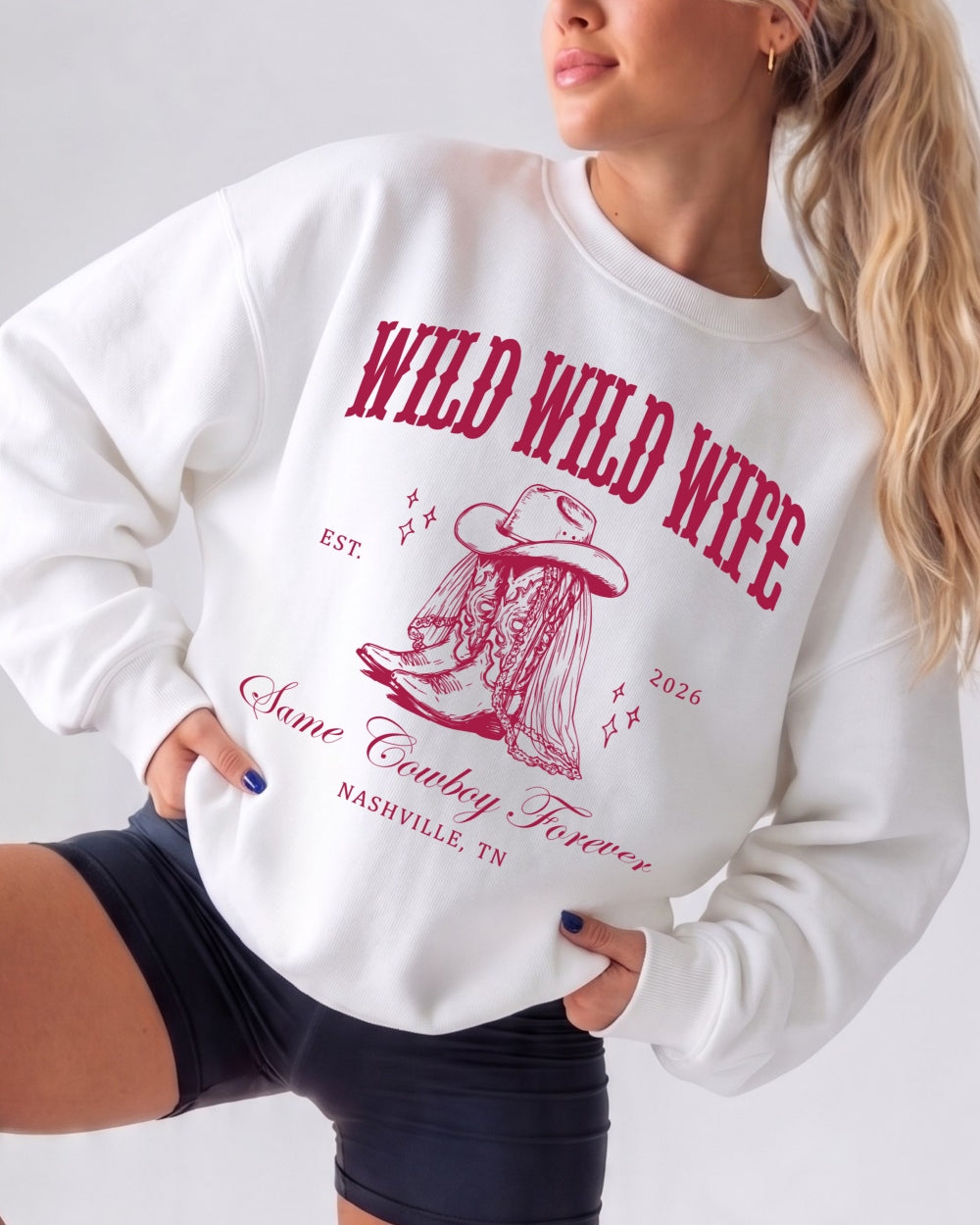 Vintage western varsity sweatshirt for bachelorette parties with bold boot graphic and retro script lettering. Country bride crew style, customizable with name, year, and destination city.