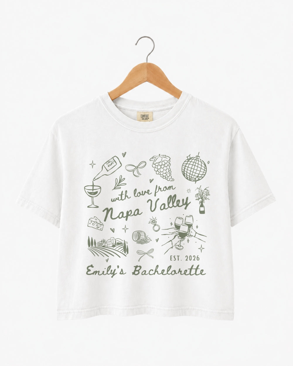 Napa Valley bachelorette weekend crop top with whimsical wine-country doodle art and script lettering. Bride name, year, and destination customizable for the whole bridal crew.