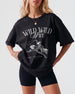 Bride and bridesmaids in matching Wild Wild Wife western tees for a rodeo bachelorette party. Vintage cowgirl illustration with script lettering for the whole bridal crew.