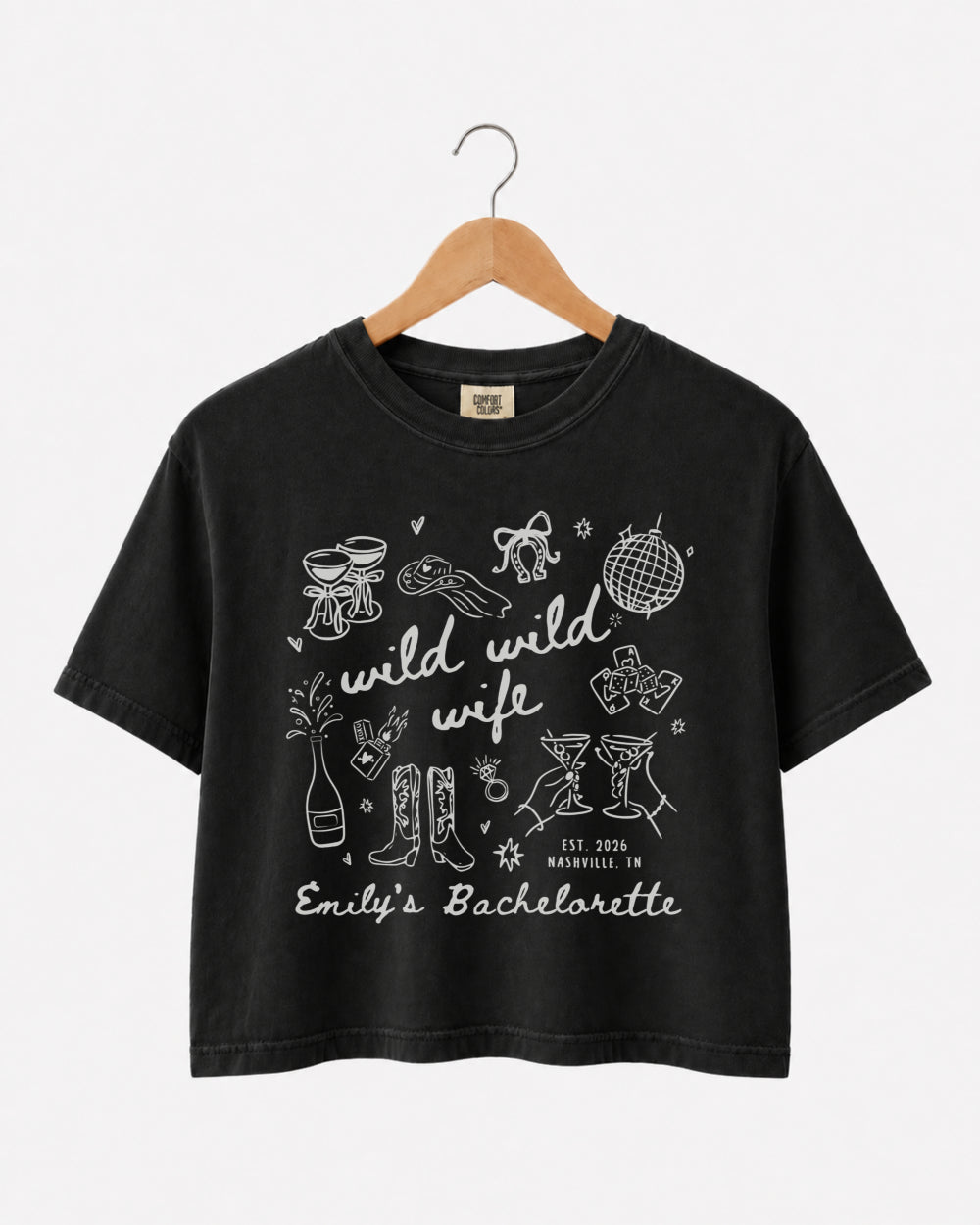 Bachelorette weekend crop top with Wild Wild Wife doodle art and script lettering. Personalized with bride name, EST year, and destination city for the whole crew.