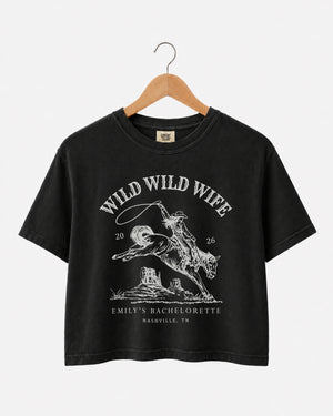Matching crop tops for the Wild Wild Wife bachelorette crew, vintage western rodeo art with retro script. Personalized with bride name, date, and city for the full party.
