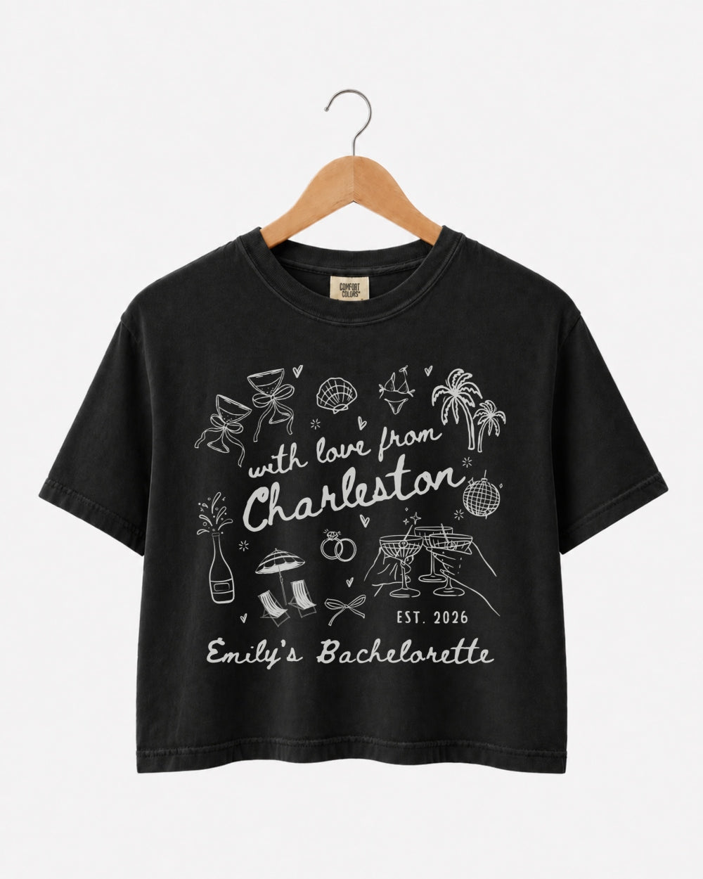 Matching crop tops for the bachelorette crew, With Love from Charleston doodle script with playful icons. Personalized with bride name, destination city, and weekend date for the whole party.