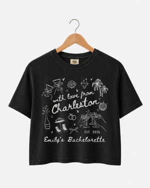 Matching crop tops for the bachelorette crew, With Love from Charleston doodle script with playful icons. Personalized with bride name, destination city, and weekend date for the whole party.