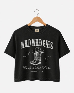 Matching crop tops for a cowgirl bachelorette crew, Wild Wild Wife western theme with vintage script art. Personalized with bride name, year, and destination city for the whole party.