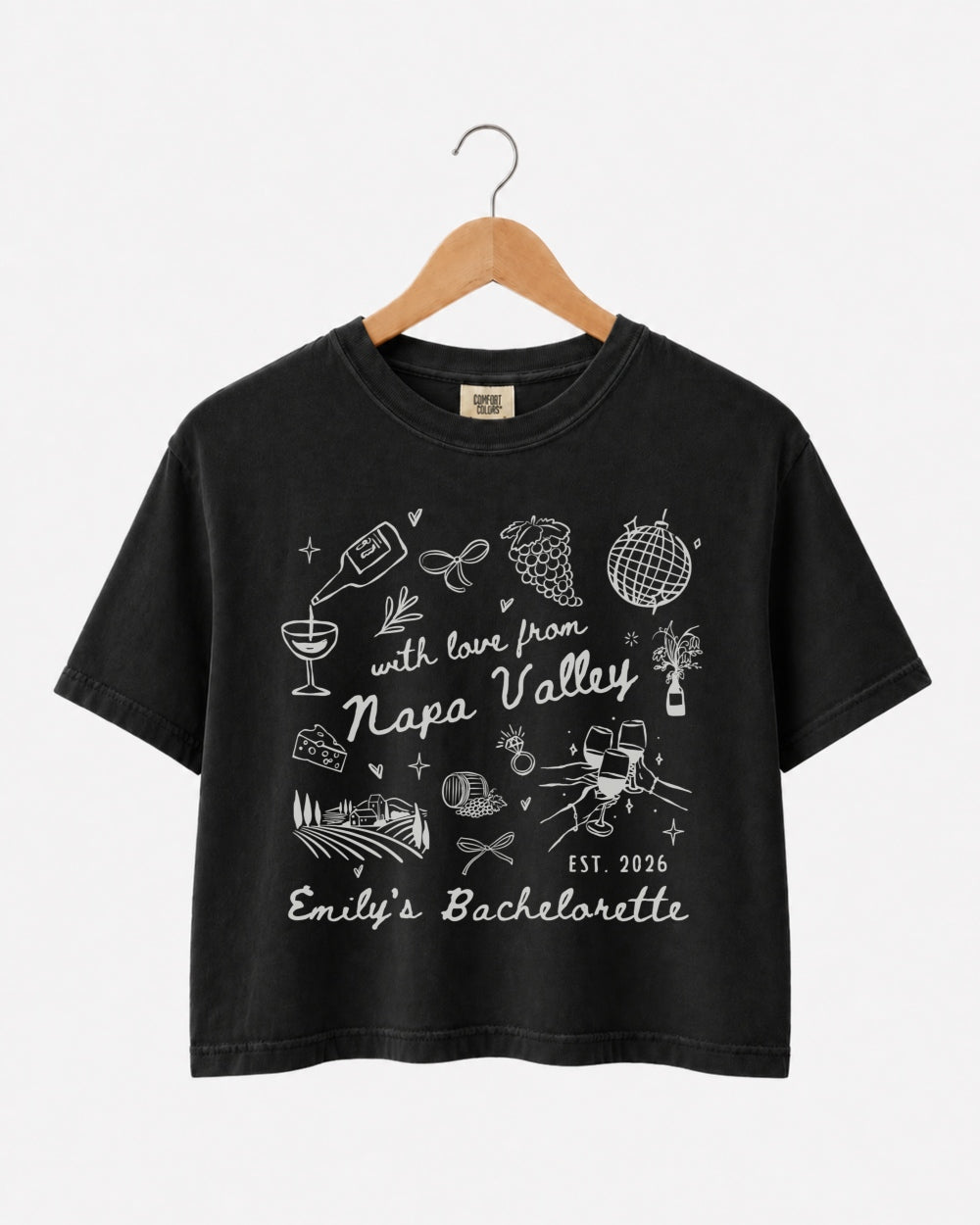 Matching crop tops for the Napa Valley bachelorette crew, whimsical wine-country doodle art with script lettering. Personalized with bride name, year, and destination for the full bridal party.