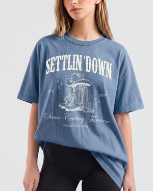 Boxy western bachelorette t-shirt with vintage rodeo illustration and cowboy boot art for the bride's last rodeo crew. Personalized with bride name, year, and destination city for the full party.