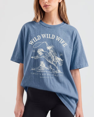 Relaxed-fit bachelorette t-shirt with vintage western rodeo art for the Wild Wild Wife crew. Personalized with bride name, destination city, and weekend date for the full bridal party.