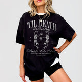 Black cotton bachelorette shirt with funny gothic skeleton bride design, perfect for a Halloween or edgy til death do us party bride tribe