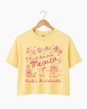 Personalized Mexico bachelorette crop top with bride name, year, and destination in playful hand-drawn script. Custom matching set for the whole bachelorette crew heading south of the border.