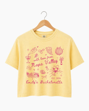 Personalized Napa Valley bachelorette crop top with bride name, year, and destination customizable. Whimsical line-art doodle design with script typography for the full bridal crew.