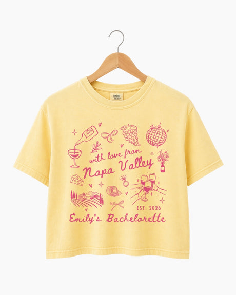 Personalized Napa Valley bachelorette crop top with bride name, year, and destination customizable. Whimsical line-art doodle design with script typography for the full bridal crew.