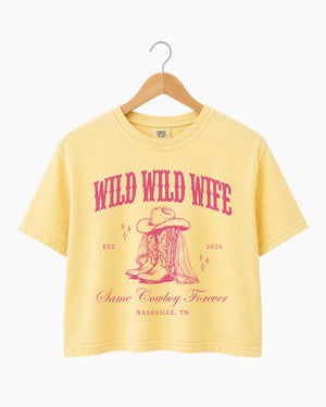 Maid-of-honor gift idea: Wild Wild Wife cowgirl bachelorette crop top with vintage western script. Personalized with bride name, year, and destination city for the full Nashville crew.