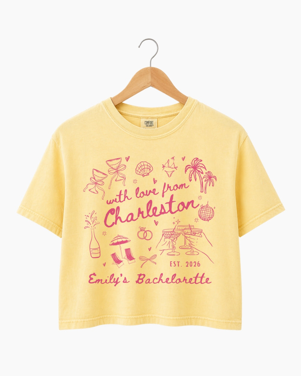 Personalized bachelorette crop top with destination city, bride name, and wedding year in hand-drawn doodle script. Custom matching set for the whole crew, perfect for a girls trip or bachelorette weekend.