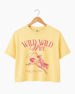 Personalized bachelorette crop top with bride name, date, and city on a vintage western rodeo design. Custom matching set for the Wild Wild Wife crew and her Last Rodeo weekend.