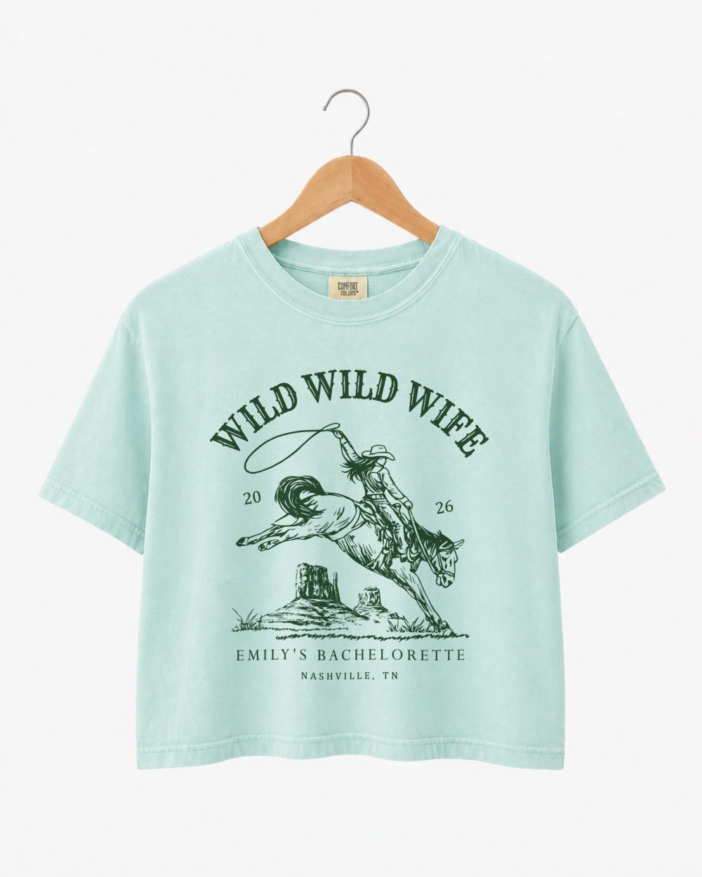 Maid-of-honor gift idea: Wild Wild Wife bachelorette crop top with vintage western art. Personalize with the bride's name, year, and destination city for the full rodeo crew.