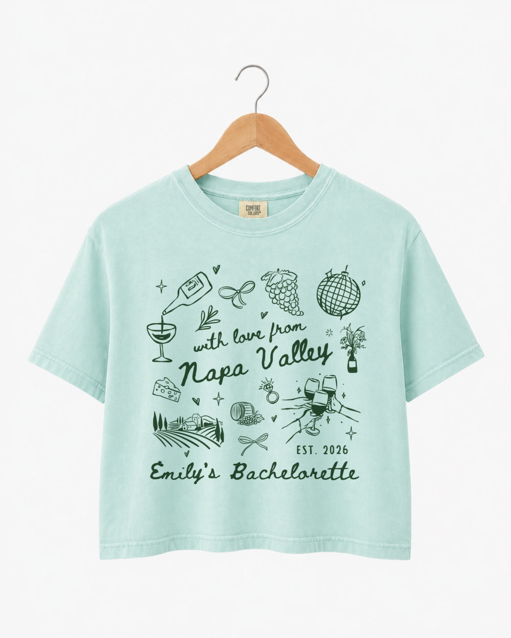 Gift idea for a Napa Valley bachelorette weekend: crop top with whimsical wine-country doodle art and script. Personalized with bride name, destination, and year for the whole crew.