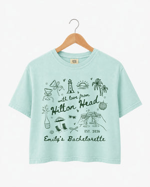 Gift idea for the bachelorette crew: Hilton Head crop top with playful line-art doodles and hand-drawn script. Personalized with bride name, destination, and EST year for the whole party.