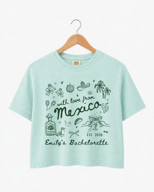Gift idea for the bachelorette crew: Mexico destination crop top with playful hand-drawn script art. Personalized with bride name, date, and destination for the whole party.