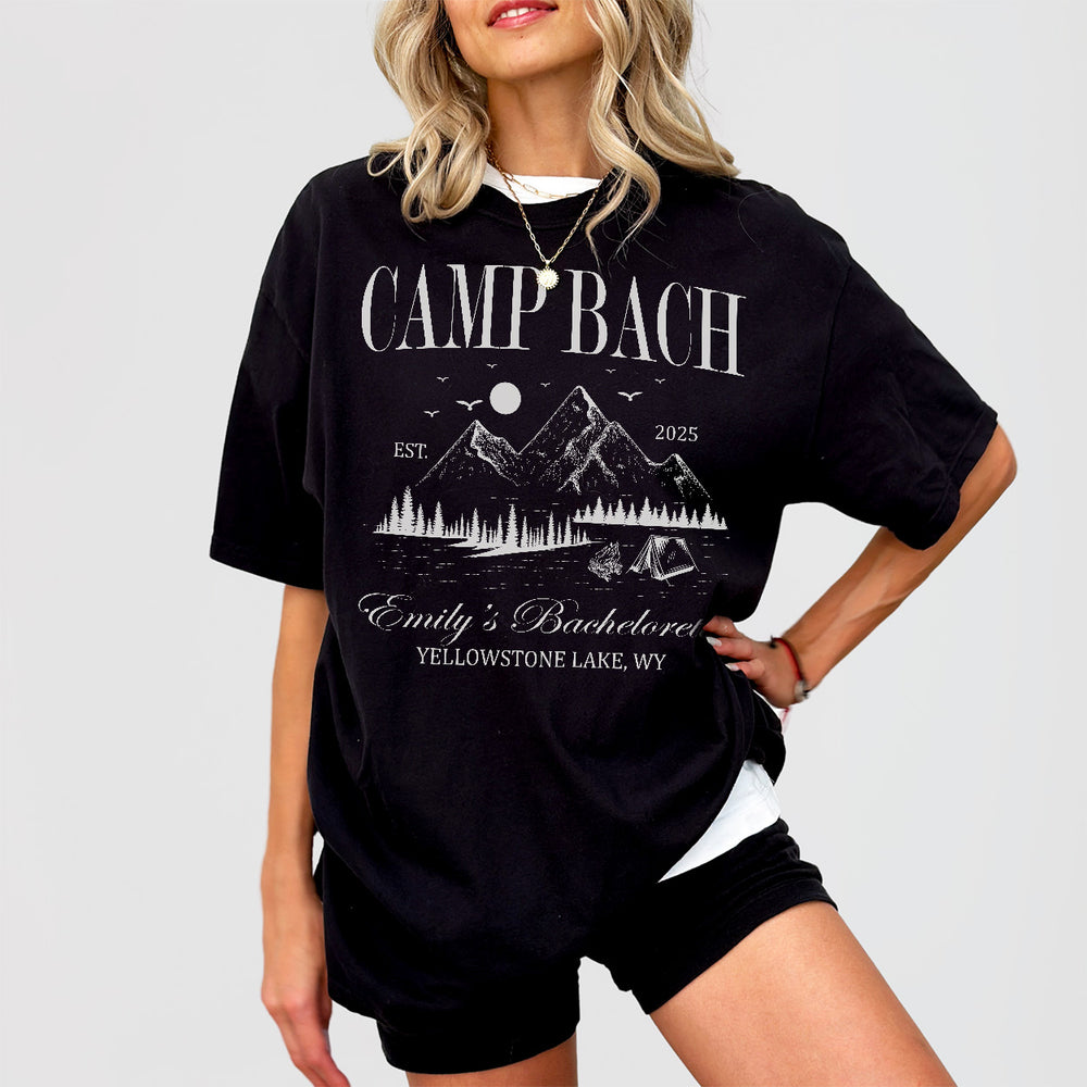 Black cotton shirts personalized for a camping bachelorette party with the bride's camp bach crew on a mountain lake trip