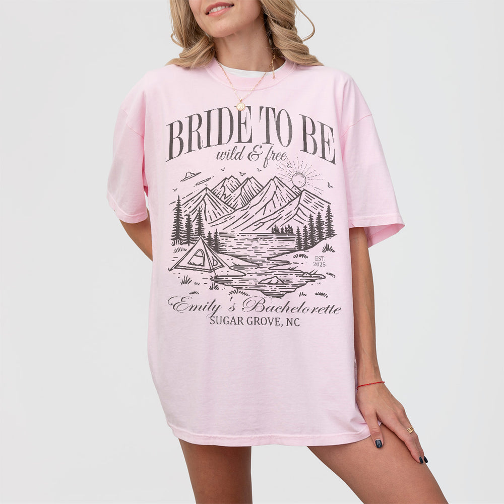 Blossom pink bachelorette party shirts with "Last Trail Before the Veil" print for the bride-to-be's camping-themed bach celebration