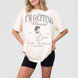 Ivory cotton bachelorette party shirt with cute cat graphic, perfect for the cat-loving bride-to-be or her bridal party's getting meowied celebration