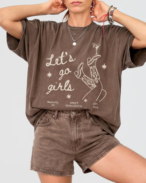 Bride and her girls night out crew in Let's Go Girls vintage line-art tees featuring cowboy boots and martini graphics. Matching bachelorette party shirts for the whole squad.