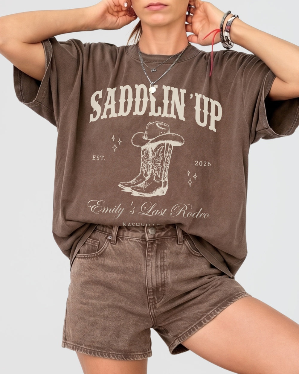 Bride and bridesmaids matching western bachelorette tees with vintage cowboy boot illustration for a Last Rodeo rodeo-theme party. Personalized with bride name, year, and destination city.