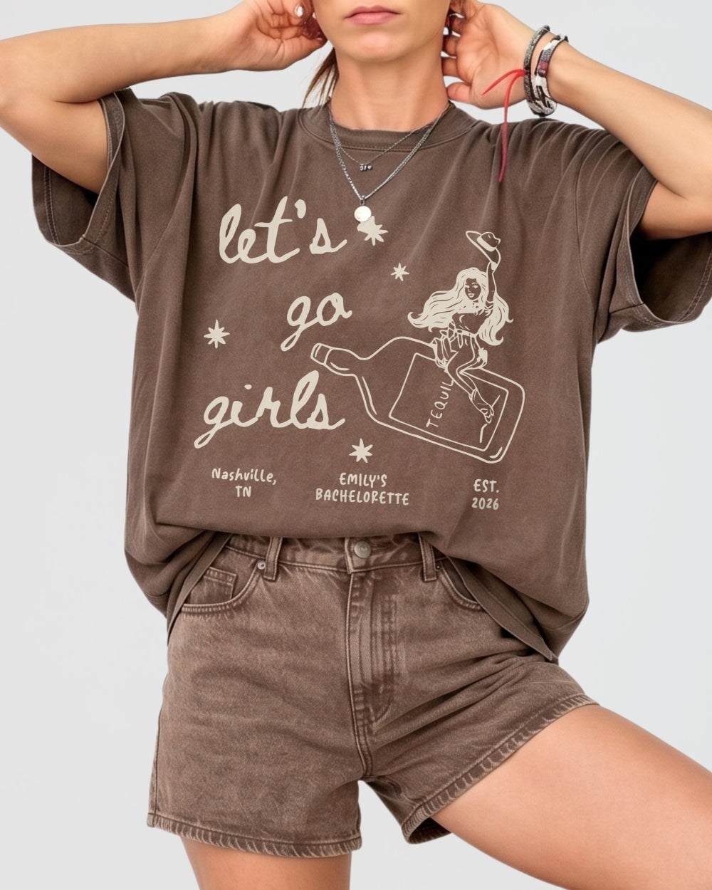 Women's girls night out tee with minimalist vintage cowgirl bottle illustration. Let's Go Girls graphic shirt for casual hangouts, concerts, and country nights out with the crew.