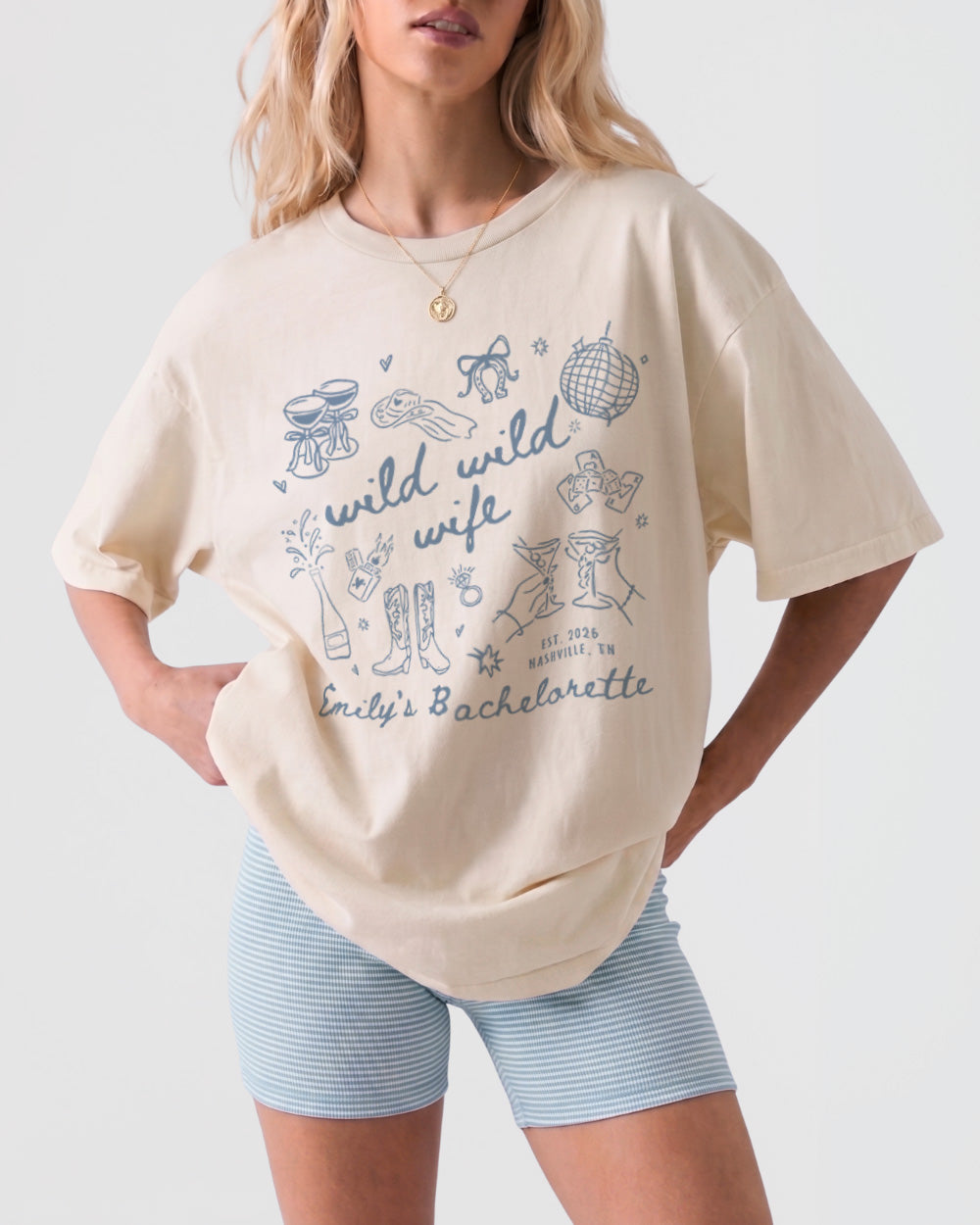 Personalized Wild Wild Wife bachelorette t-shirt with whimsical doodle art and script lettering. Custom bride name and weekend details make it the perfect matching tee for the whole bridal crew.