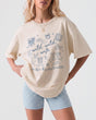 Personalized Wild Wild Wife bachelorette t-shirt with whimsical doodle art and script lettering. Custom bride name and weekend details make it the perfect matching tee for the whole bridal crew.