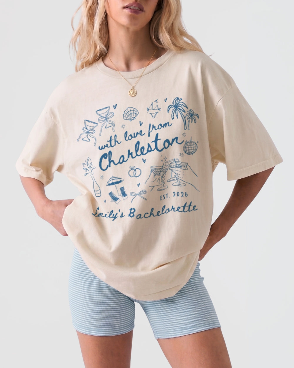 Vintage script bachelorette tee with decorative doodle icons and a Charleston destination theme. Personalized with bride name, city, and est. year for the full crew.
