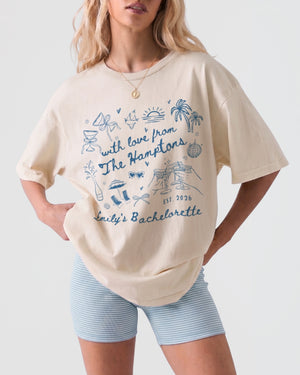 Whimsical line-art doodle bachelorette tee with script lettering and Hamptons-themed artwork for the bride and her crew. Personalized with bride name, destination, and year.