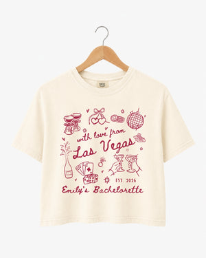 Las Vegas bachelorette weekend crop top with vintage line-art illustration and script lettering. Personalized with bride name, year, and destination city for the whole crew.