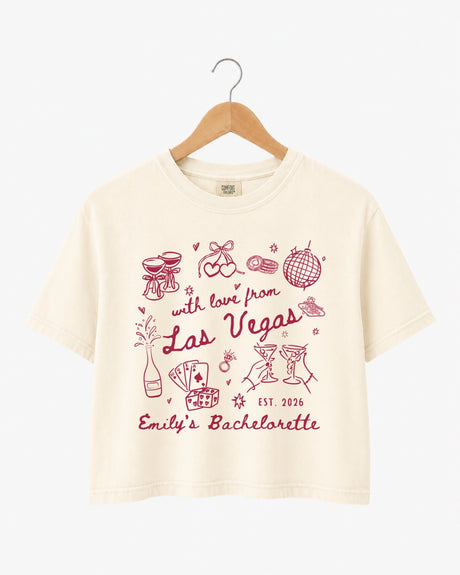 Las Vegas bachelorette weekend crop top with vintage line-art illustration and script lettering. Personalized with bride name, year, and destination city for the whole crew.