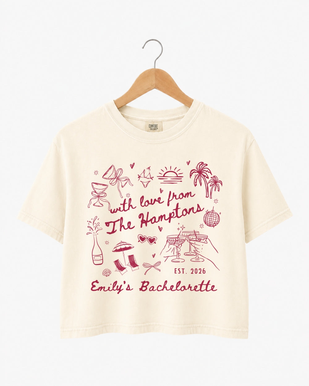 Bachelorette weekend crop top with playful illustrated doodles and script lettering. Personalized with bride name, year, and destination for the whole crew. Perfect for a Hamptons girls trip.